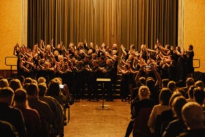 Full choir of Inner West Voices on stage at Petersham Town Hall. Photo by Assemble Photography.