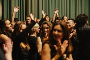 Choir members preparing to perform backstage. Photo by Assemble Photography.
