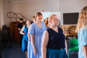 Choir members preparing to perform backstage. Photo by Assemble Photography.