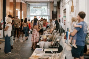 Crowds browsing stalls and art displays at the Palava Artist Collective Christmas Market, Waterloo. Photo by Assemble Photography.