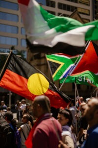 Protesters with Palestinian flags at pro-Palestine rally in Sydney, February 2024. Photo by Assemble Photography.