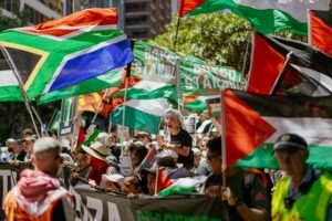 Protesters with Palestinian flags at pro-Palestine rally in Sydney, February 2024. Photo by Assemble Photography.