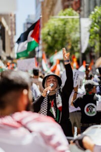 Protesters with Palestinian flags at pro-Palestine rally in Sydney, February 2024. Photo by Assemble Photography.