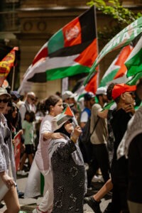 Protesters with Palestinian flags at pro-Palestine rally in Sydney, February 2024. Photo by Assemble Photography.