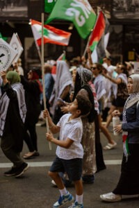 Protesters with Palestinian flags at pro-Palestine rally in Sydney, February 2024. Photo by Assemble Photography.