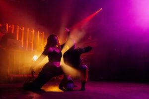 begeki performing at INSEQUENCE under light art. Photo by Assemble Photography.