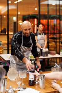 Guests preparing drinks at the mocktail masterclass, Volcanos Steakhouse, Stockland Wetherill Park. Photo by Assemble Photography.