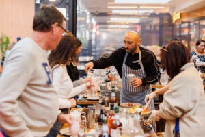 Guests preparing drinks at the mocktail masterclass, Volcanos Steakhouse, Stockland Wetherill Park. Photo by Assemble Photography.