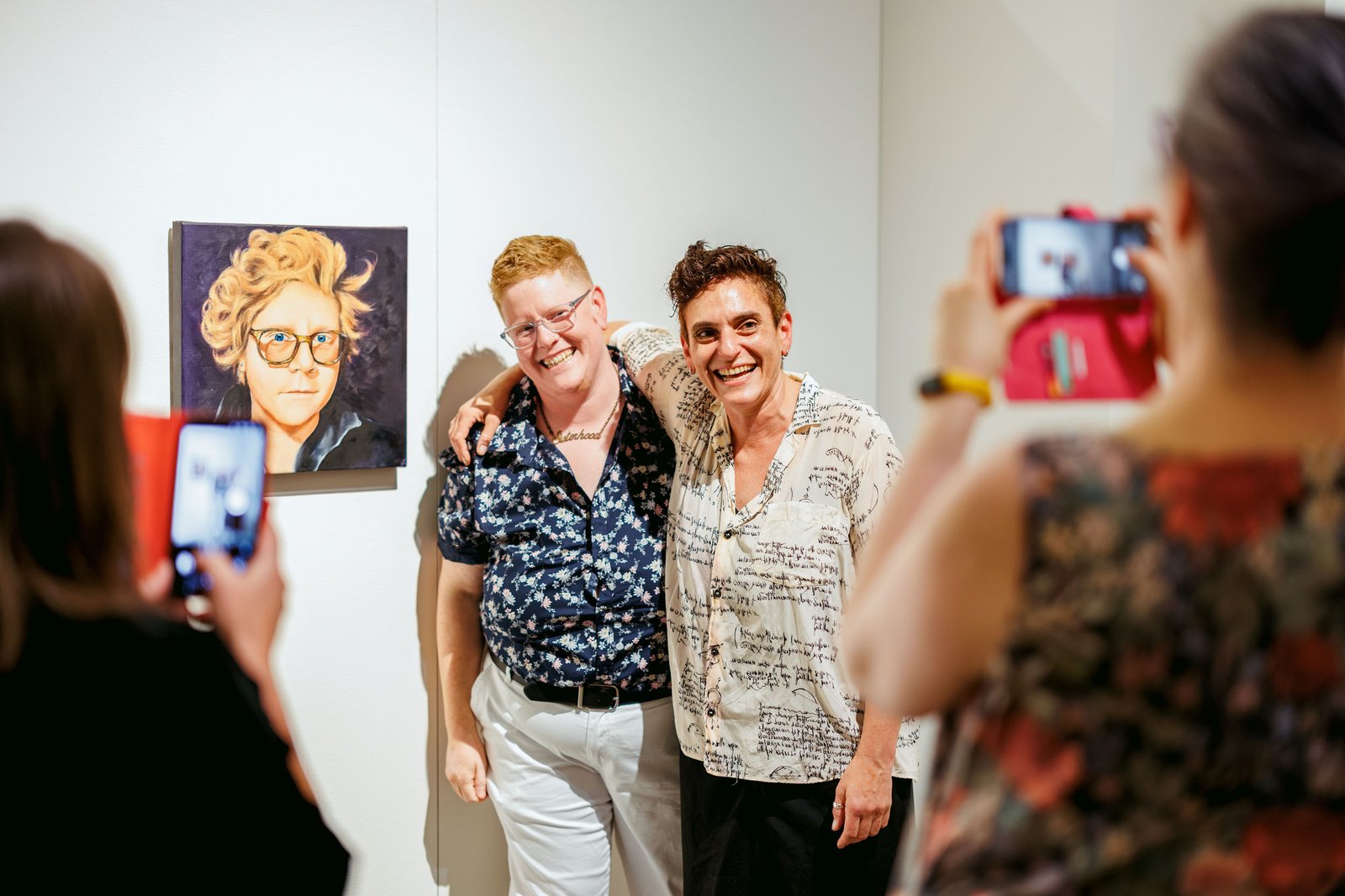 Three people posing together inside the Blue Mountains Portraits exhibition
