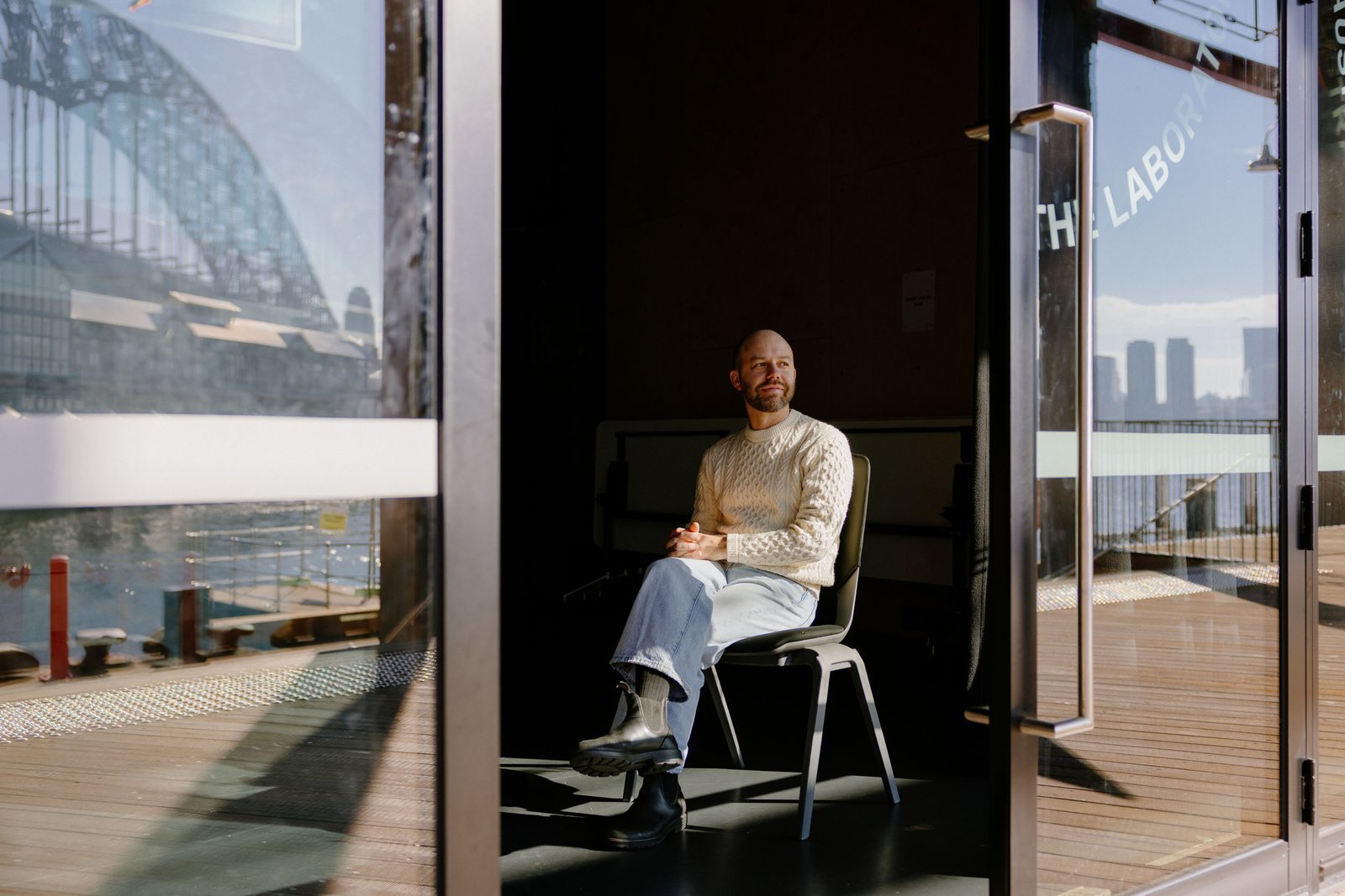 Man seated in a sunlit doorway at Australian Theatre for Young People
